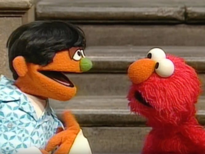 Elmo speaks to another Muppet