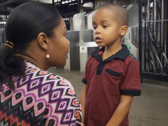 Parent talking to their child in the subway.