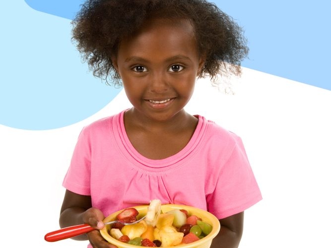 A child with a bowl of fruit.