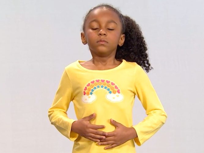 A child doing deep breathing.