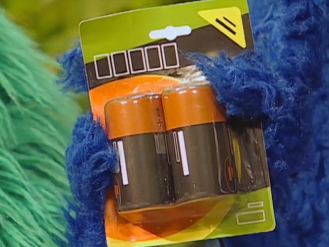 Cookie Monster holding batteries