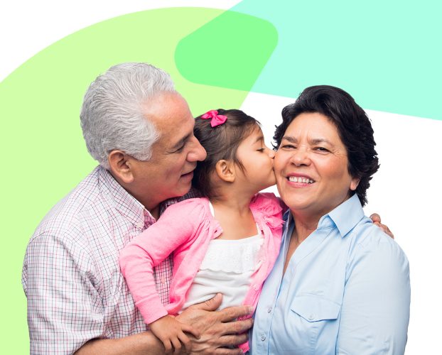 A child kisses their grandparents