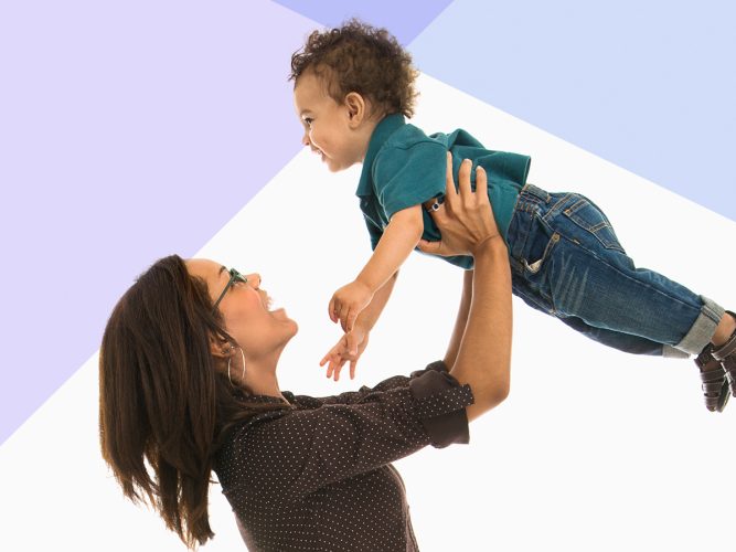 A parent lifting their child in the air.