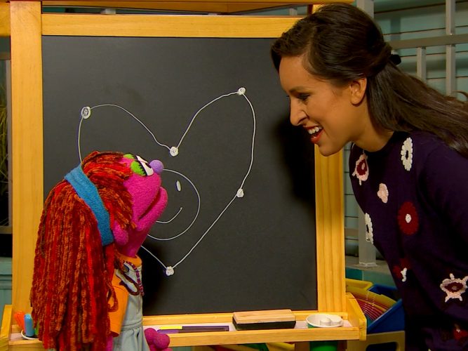 Sophia and Lily drawing a heart.