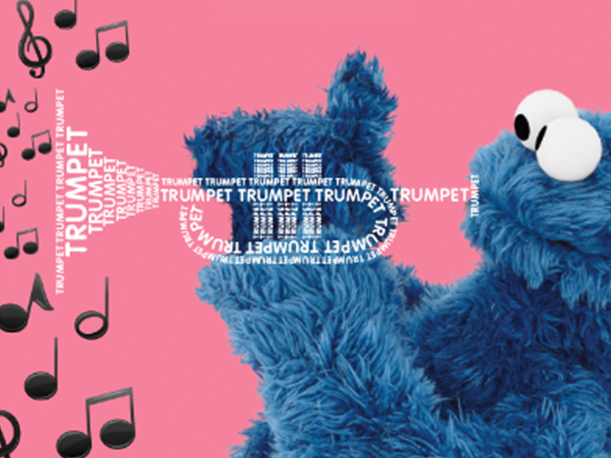 Cookie Monster holding a trumpet made of the words 'Trumpet'