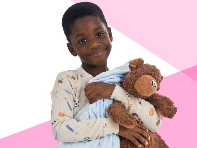 A child holds their blankie and teddy bear