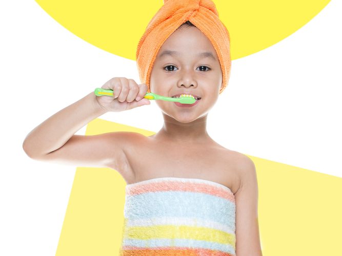 A child brushes their teeth