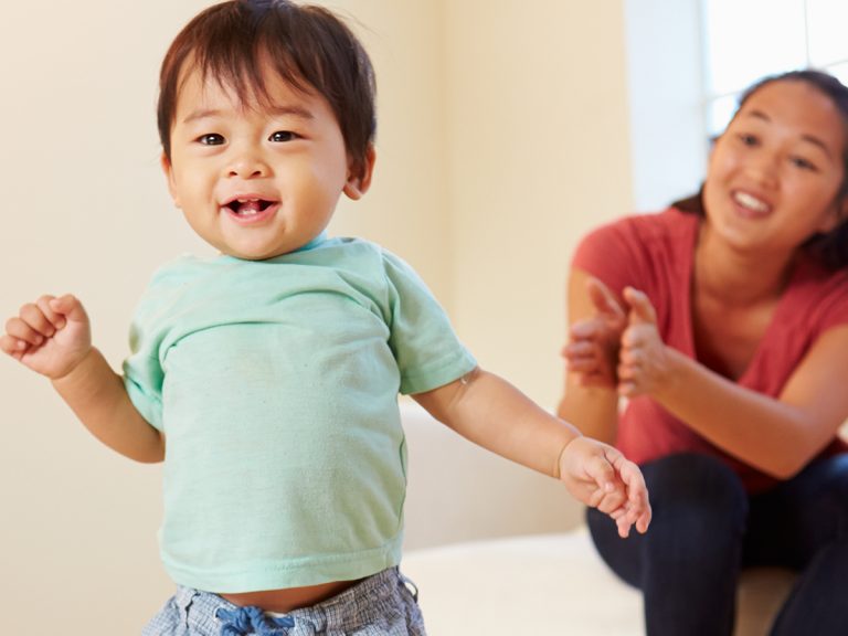 A parent watching their toddler walk.