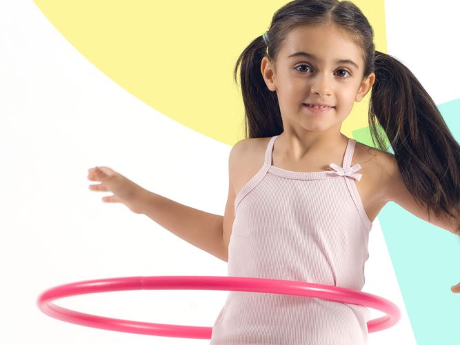 A child playing with a hula hoop