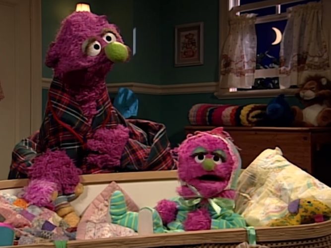 A Sesame Street Muppet and a child Sesame Street Muppet.