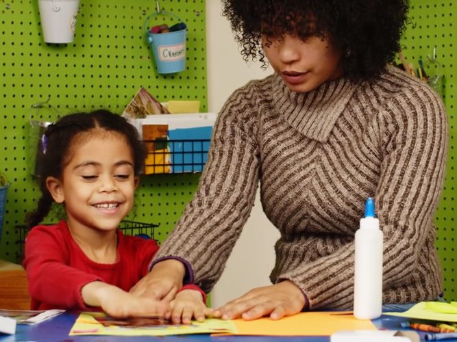 Grown-up and child doing crafts.