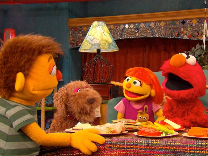 Samuel, Rose, Julia and Elmo having an indoor picnic.