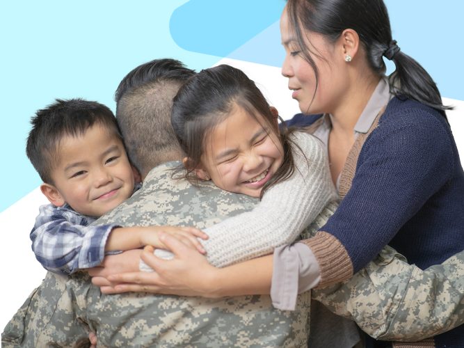 A military family hugging.