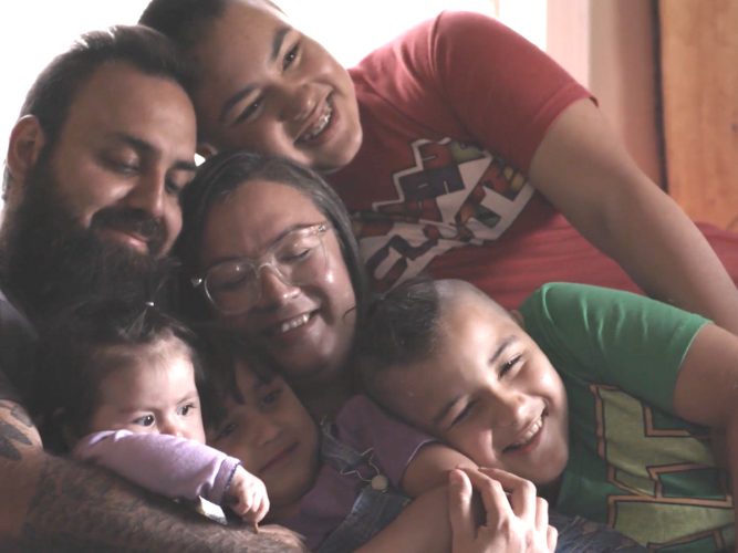 A large family hugging.