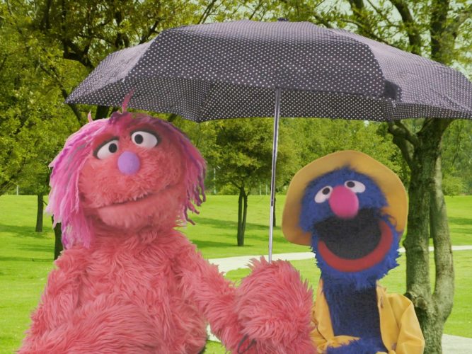 Grover and a friend under an umbrella.