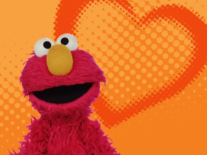 Elmo in front of a heart.