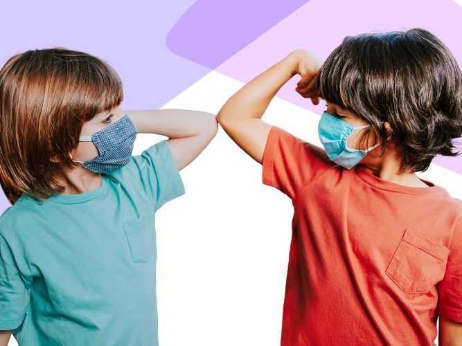 Two boys touching elbows while wearing masks.