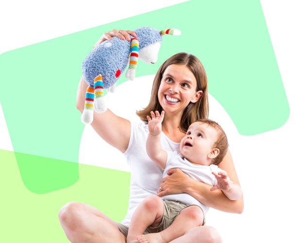 A parent playing with their baby and a stuffed toy.