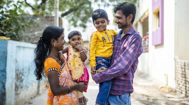 Parents holding their children.