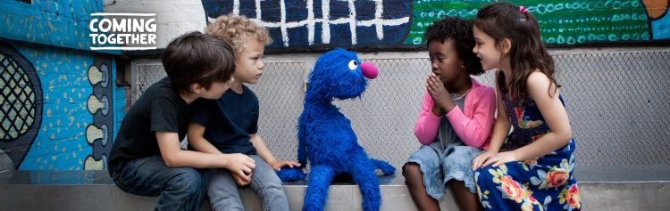 Grover sitting with a group of children.