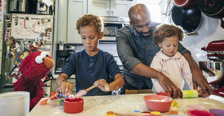 A family baking with Elmo.