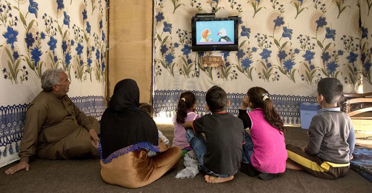 A family watching Sesame Street.