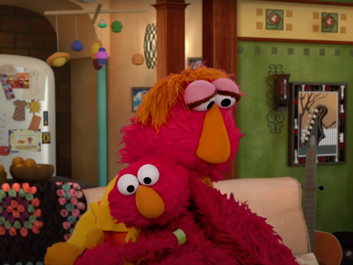 Elmo and dad hugging.