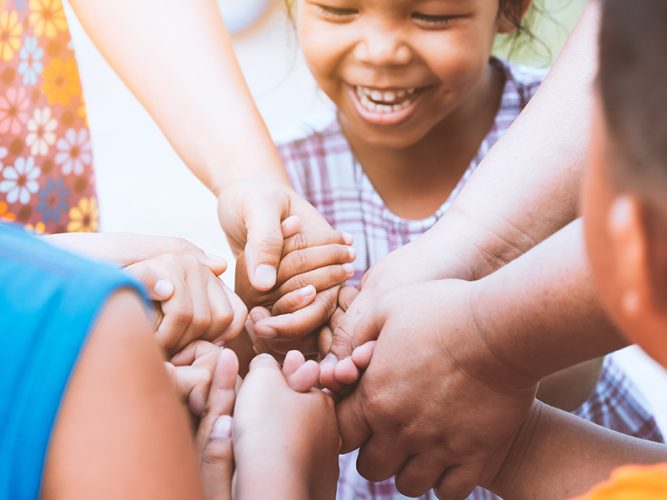 A group of children holding hands.