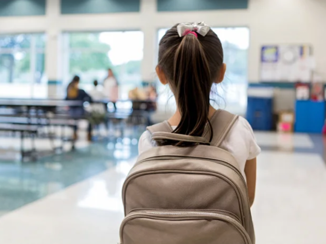 Girl with a backpack in school