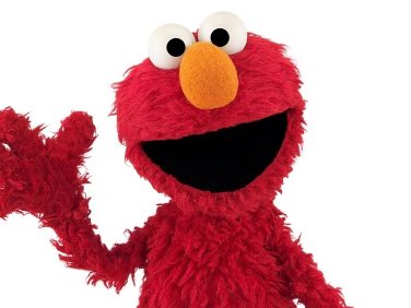 Elmo waves at us.