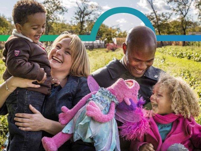 A family laughing with Abby on a farm.