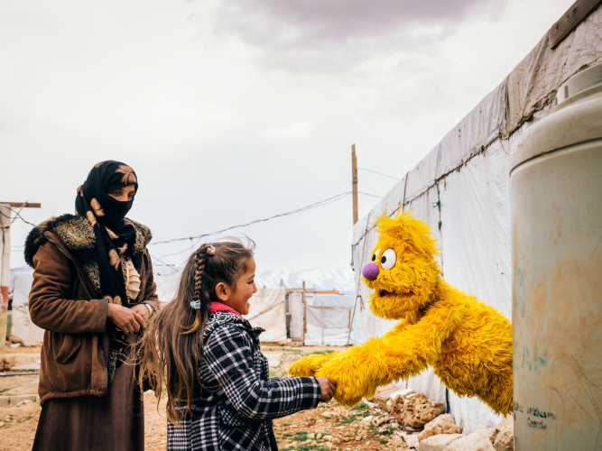 Jad shaking hands with a child.