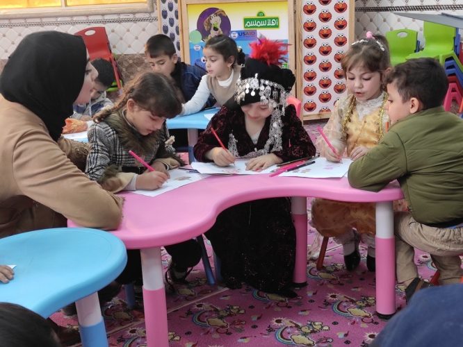 Children partake in Ahlan Simsim activities dressed in their traditional clothing in Mosul, Iraq. / Save the Children