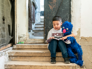 Grover reading with a child.