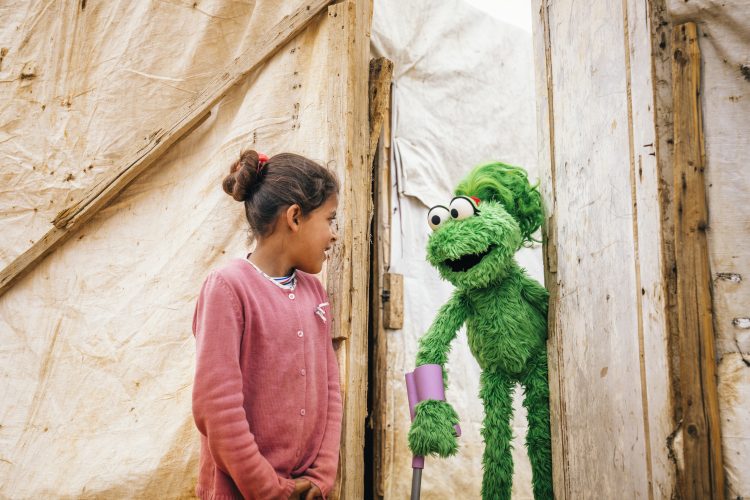 Ameera laughing with a child.