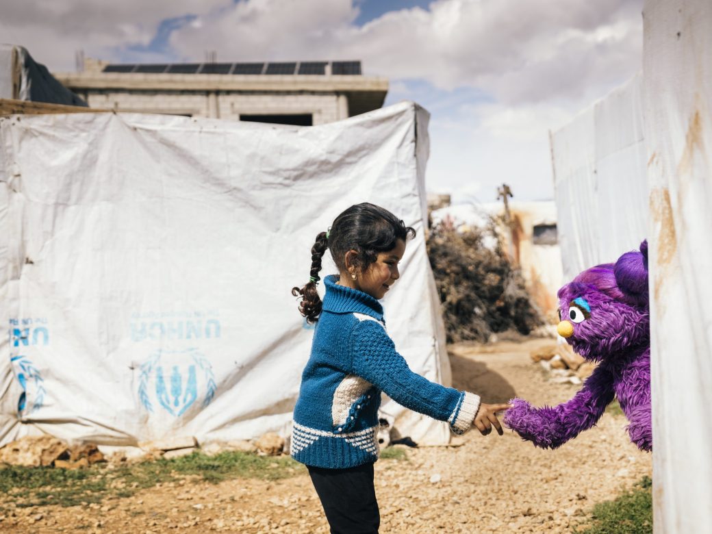 Basma holding a child's hand.