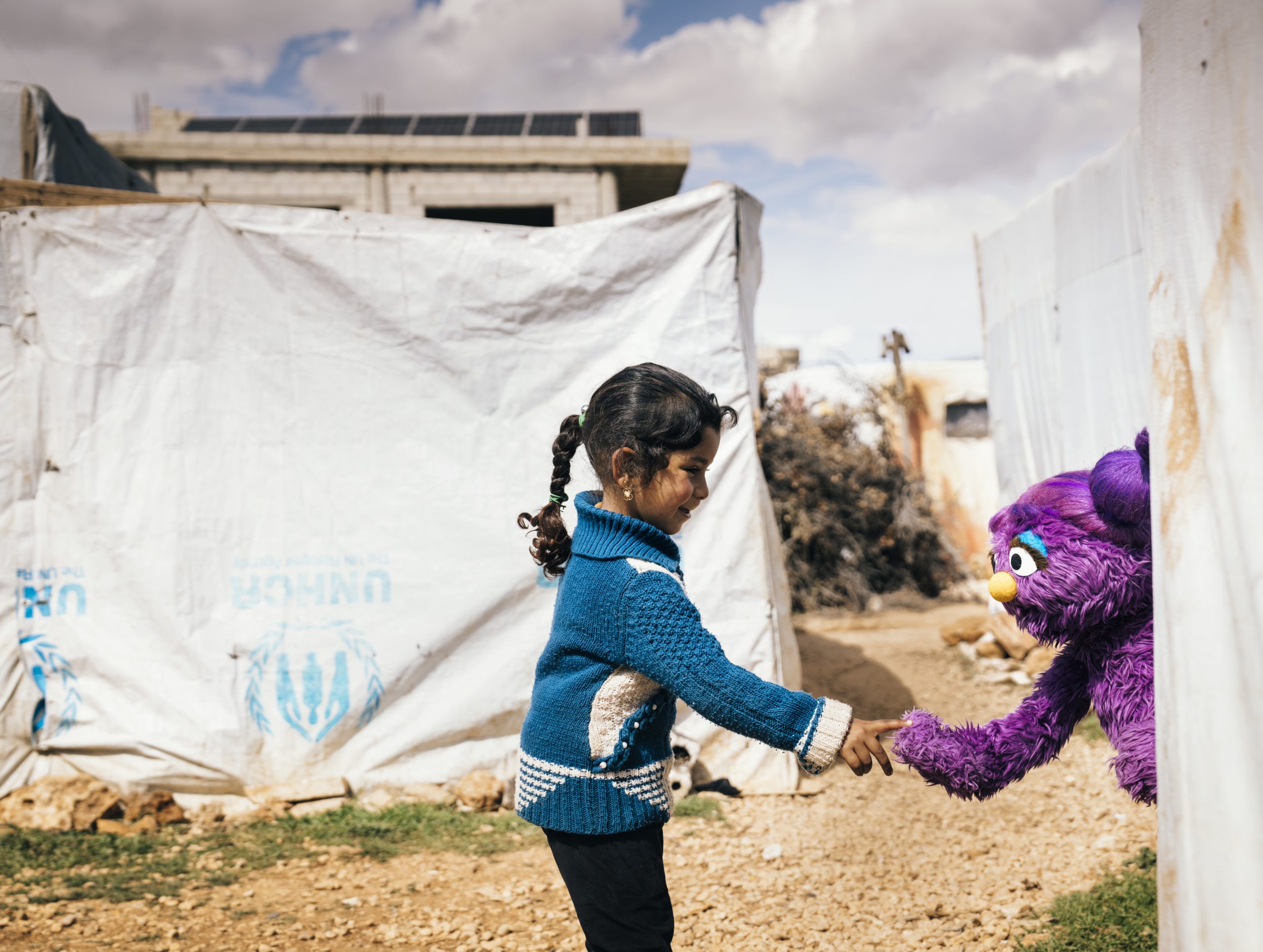 Basma holding a child's hand.