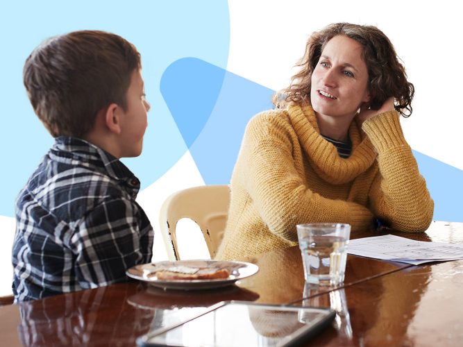 A parent and child talking at a table.