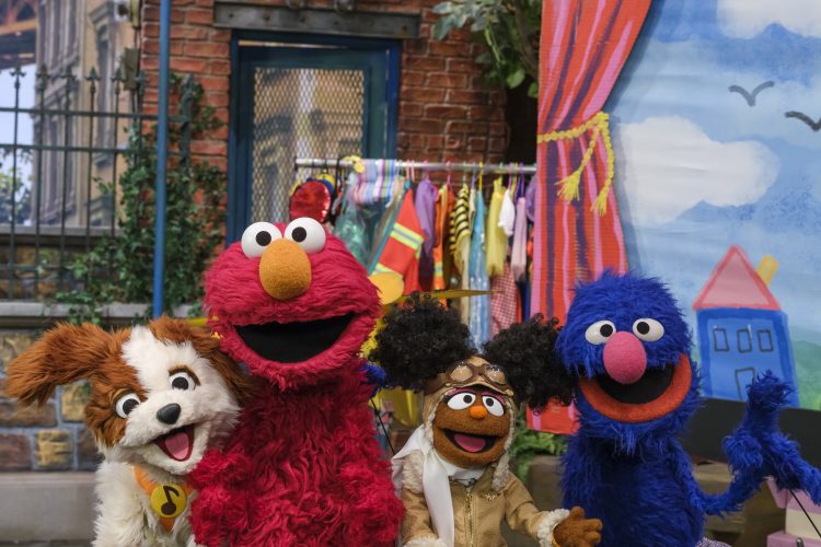 Tango, Elmo, Gabrielle dressed as a pilot, and Grover.