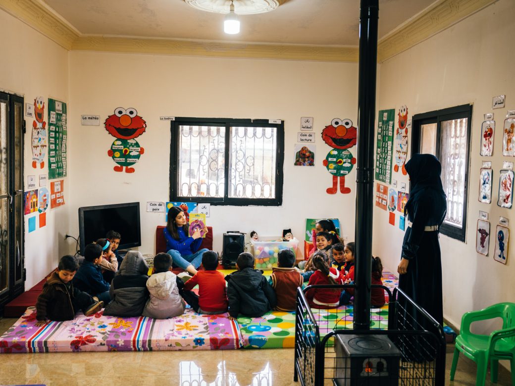 A teacher in a classroom with students.