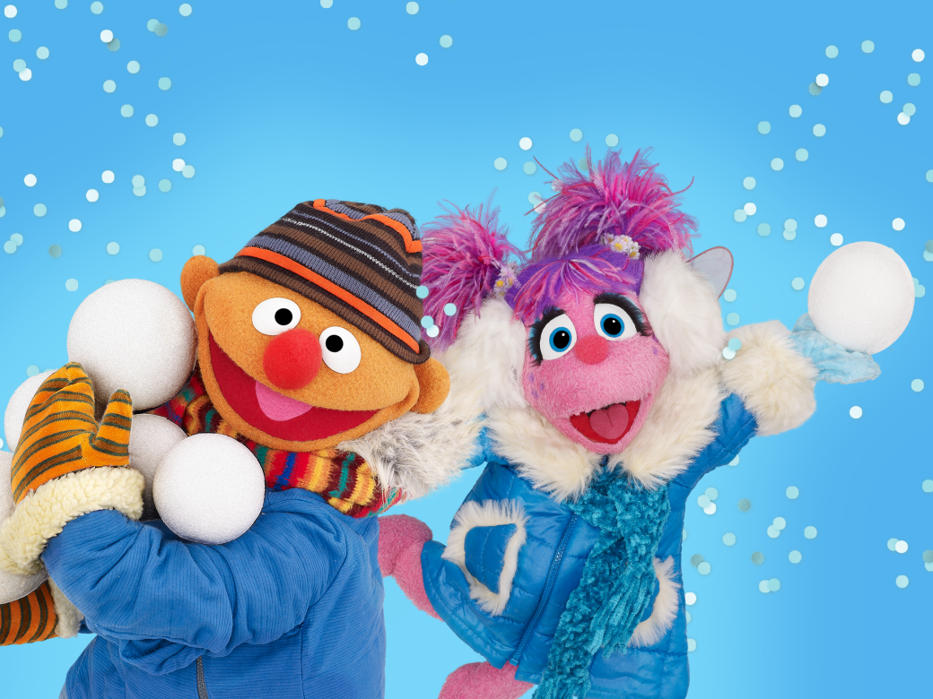 Ernie and Abby pose in a winter wonderland with snowballs.