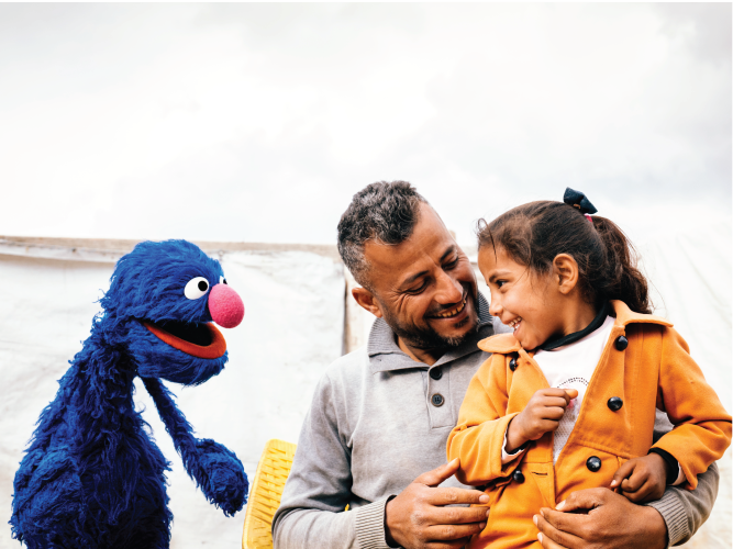 A parent and child with Grover.