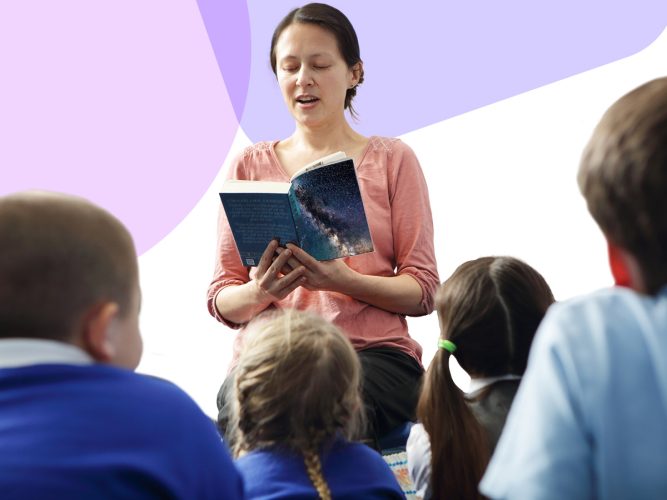 An adult reads aloud to a class of students.