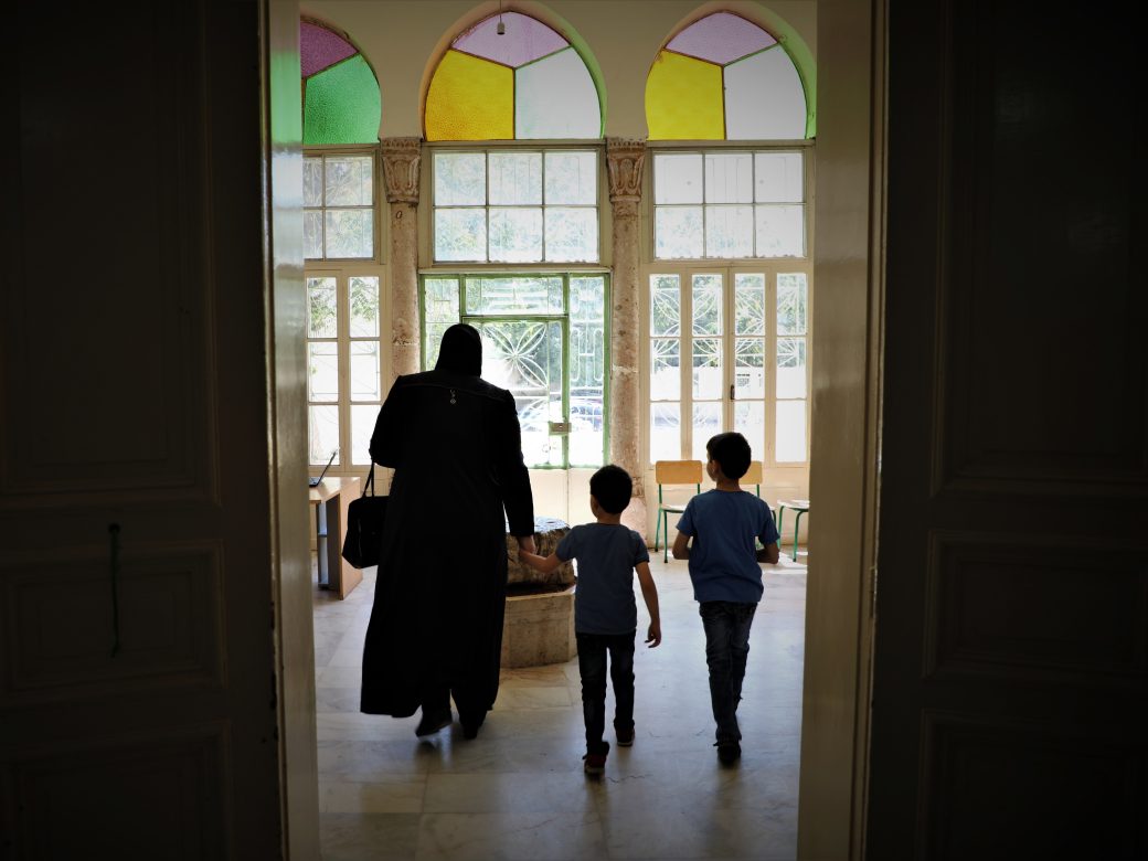 A family walking out of a building.