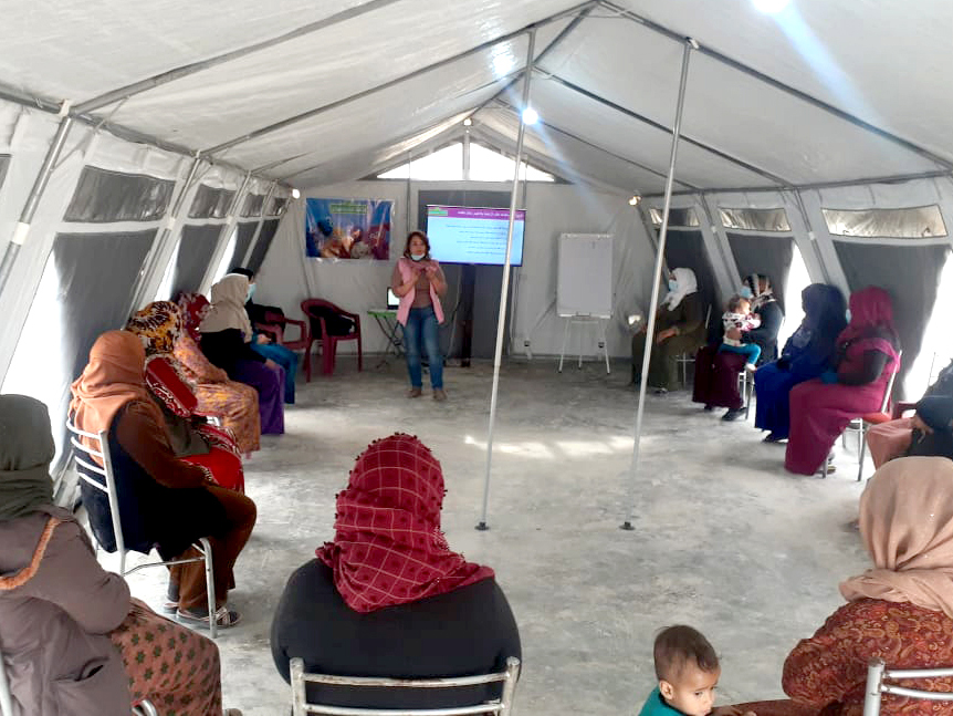 Providers meeting in a tent.