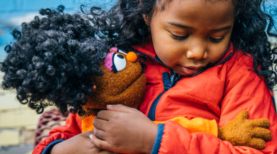 Child and Gabrielle hugging.