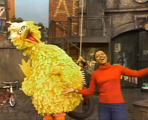 Big Bird and a person dancing.