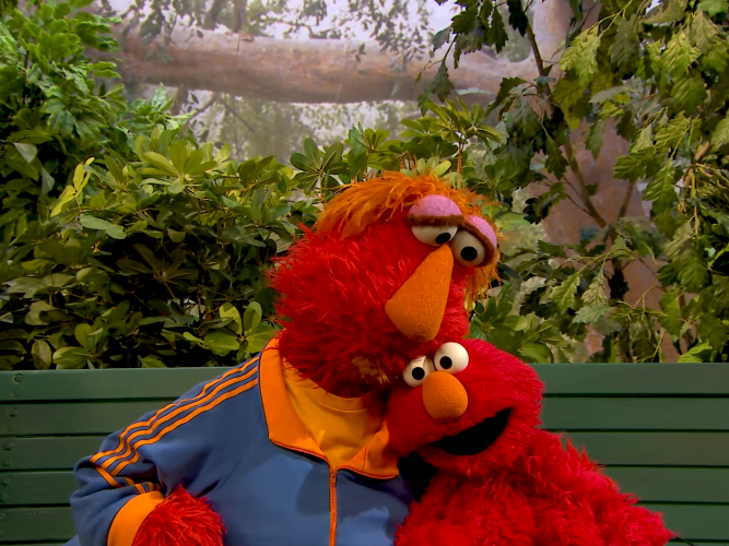 Louis hugging Elmo