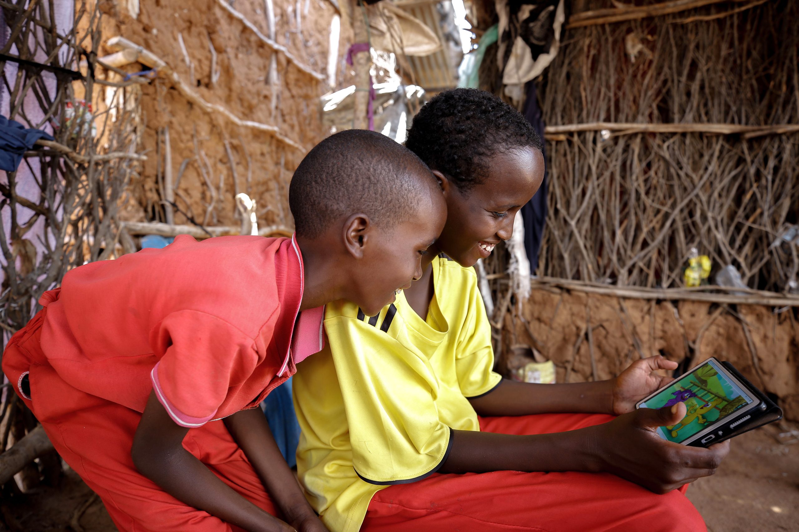 Children watching a show on a tablet.