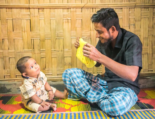 A father plays with his baby